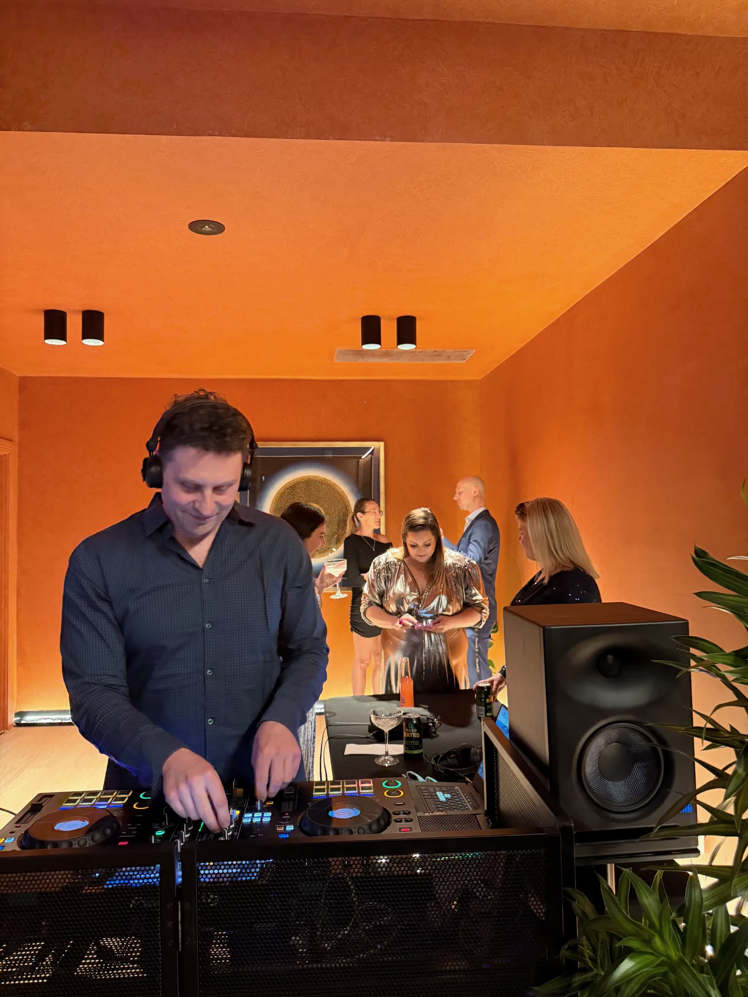 A DJ playing in the clay-walled lounge